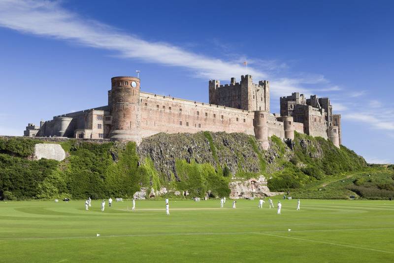 Playing Cricket below Bamburgh Castle, Northumberland